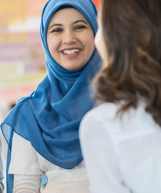 A woman in a hijab smiling. 