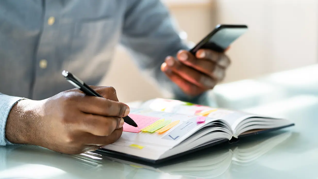 Professional looking at events in a calendar planner.