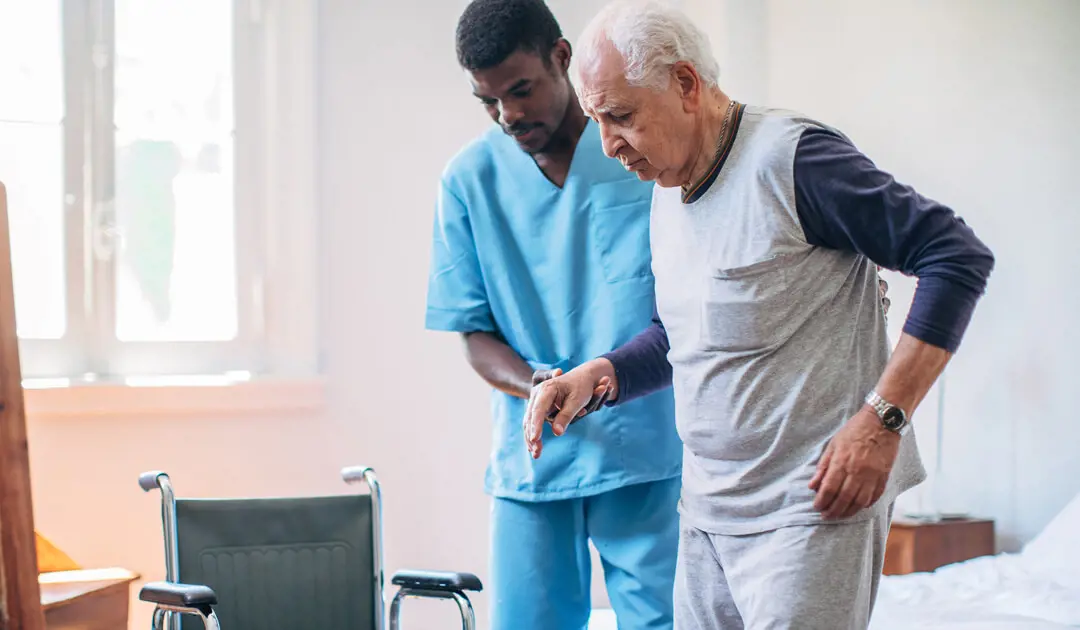 A medical professional helping an elderly patient with rehab.